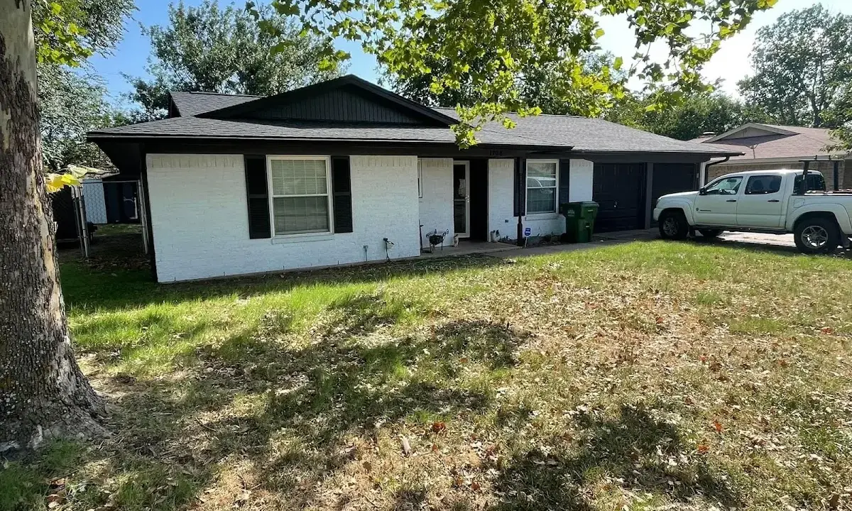 Professional roofing crew working on a residential roof in Medina